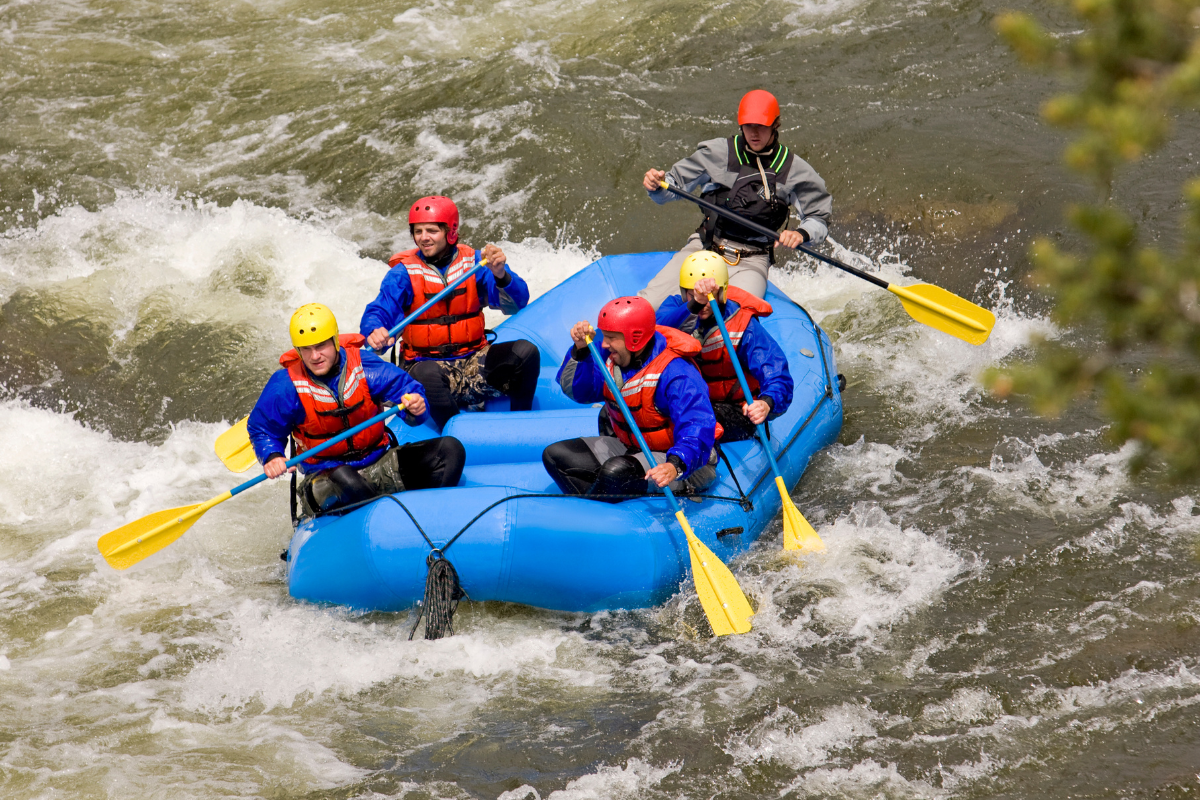 a group of people riding on a raft in a body of water