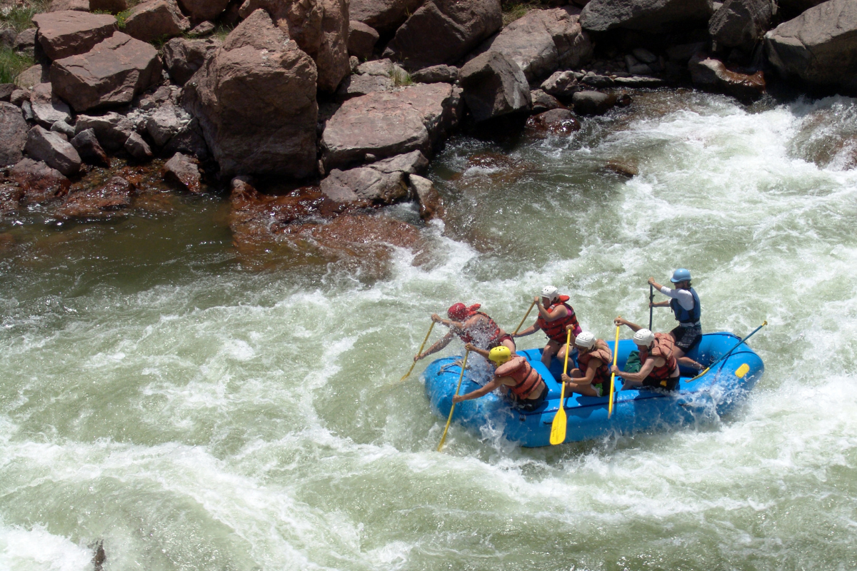 a group of people on a raft in the water