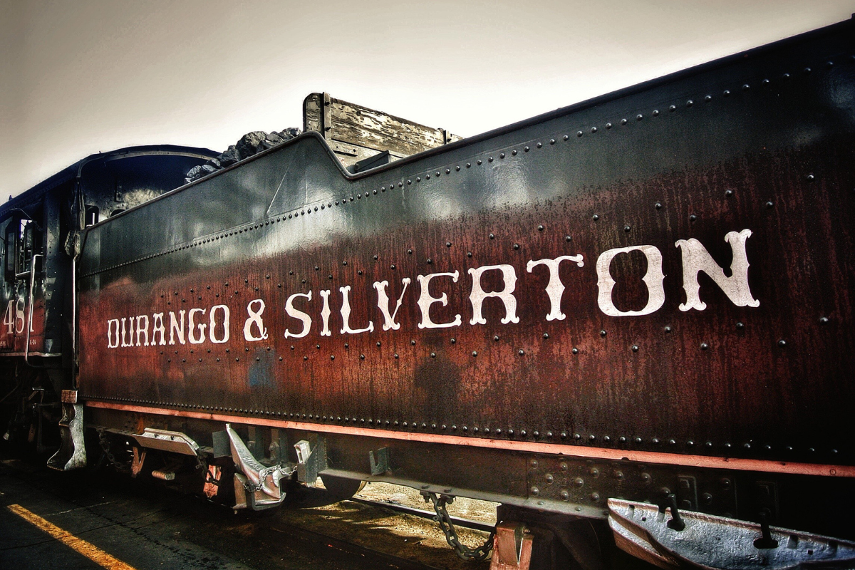 a train on a track with graffiti on the side