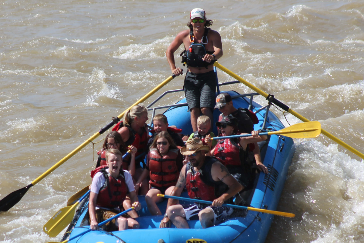 a group of people on a raft in a body of water