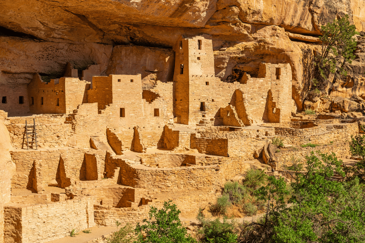 a group of cliff with Mesa Verde National Park in the background