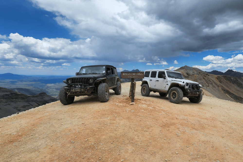 two jeeps parked on top of Imogene Pass in Colorado's Rocky Mountains